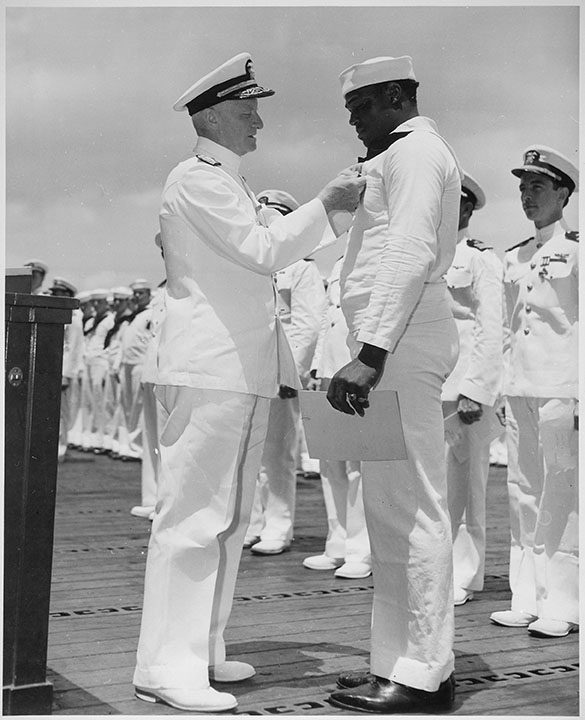 Admiral Chester W. Nimitz (left) pins the Navy Cross on Doris Miller (right) in May 1942. (National Archives and Records Administration)