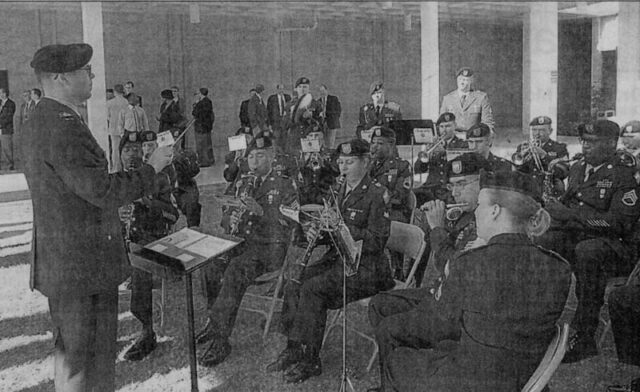 Chief Warrant Officer W. Scott MacDonald conducts the Signal Corps Band as they perform at Fort Gordon. The band played during the June 2 promotion ceremony for Maj. Gen. Janet Hicks. (Credit: Annette M. Drowlette)