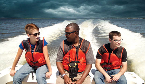 Lawrence Kiage (center), assistant professor of geosciences at Georgia State University, and graduate assistants Amber Keller (left) and Dan McCartha (right), cross the Intracoastal Waterway in a Department of the Interior Boat, motoring from the mainland at Saint Marys, Ga. to Cumberland Island.
